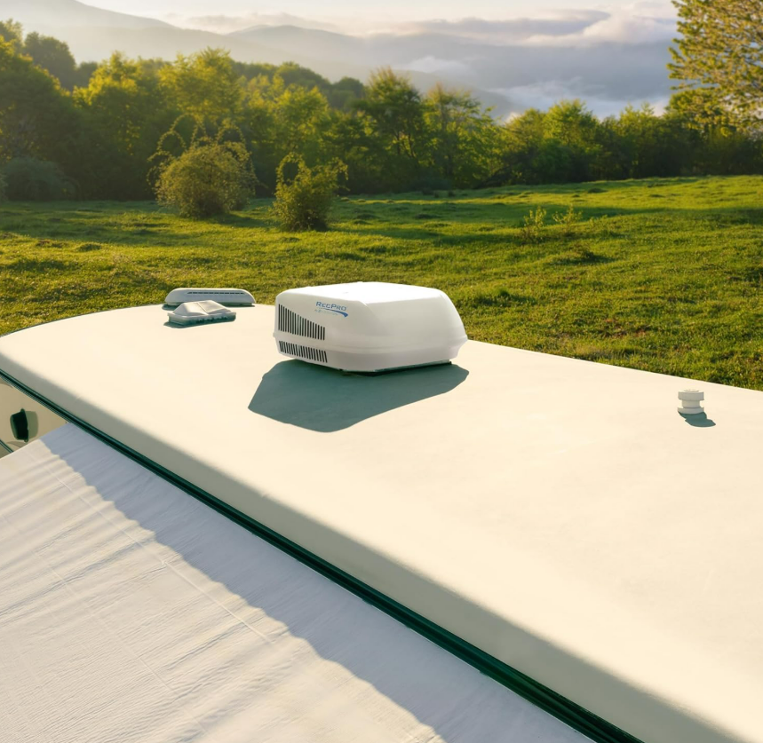 RecPro RV Air Conditioner 15K installed on an RV roof in a quiet campsite setting